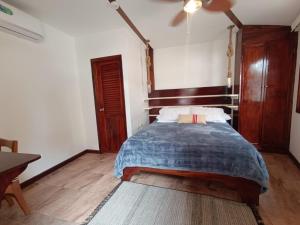 比亚米尔港木屋酒店的一间卧室配有一张床和吊扇