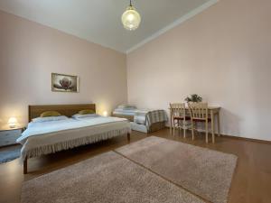 玛丽亚温泉Anzio apartments的一间卧室配有两张床和一张桌子及椅子