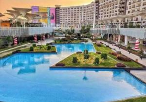 开罗Entire duplex for a lovely vacation in Nyoum New Cairo的蓝色建筑中的一个大型游泳池