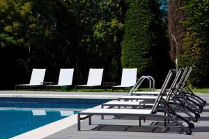 圣库加特德尔瓦勒斯圣库加特AC酒店，万豪生活酒店的游泳池旁的一排躺椅