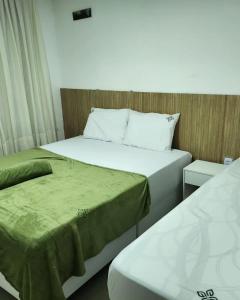 巴纳内拉斯Apt 202 e 203 no ZUPPOLINI GARDEN HOTEL Bananeiras PB的小型客房配有两张床,