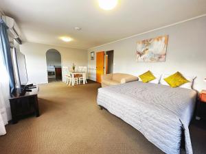旺阿雷金斯伍德庄园汽车旅馆的卧室配有1张床、1张桌子和1把椅子