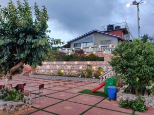 瓦伊Hilltop Resort and Agro Tourism Wai, Near Panchgani的一个带红砖墙的后院和一个游乐场