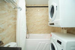 河内Sumitomo10 Apartments Dao Tan的一间带洗衣机和浴缸的浴室