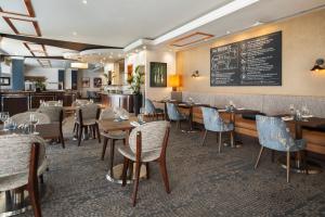 贝克斯利黑思Delta Hotels by Marriott Bexleyheath的一间带桌椅和黑板的餐厅