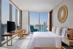 迪拜The St. Regis Downtown Dubai的一间卧室配有一张床和一张带电脑的书桌