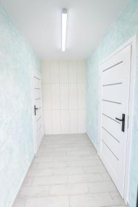 扎托尔KempingZator的一间空房间,有两个白色门和蓝色的墙壁