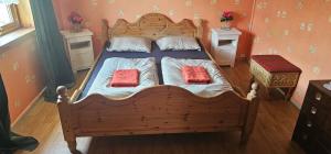 斯特兰达Holiday home among the pearls of Norway的一间卧室配有一张带两个红色枕头的木床