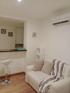 拉普拉塔Excelente Monoambiente Monito 15的客厅配有白色沙发和凳子
