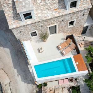 Gornji HumacShe House - built for pleasure - Island of Brač的享有带游泳池的房屋的空中景致