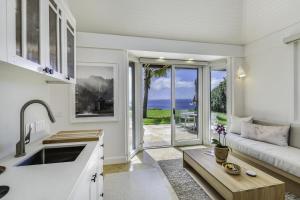 KilaueaHale Nanea home的厨房以及带沙发和桌子的客厅。