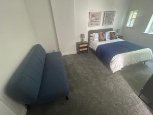 曼彻斯特The King Stay的一间卧室配有一张床和一张蓝色椅子