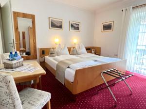巴特莱辛哈尔LANDHAUS luise的酒店客房设有一张大床和一张桌子。