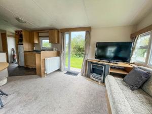 斯凯格内斯Homely 8 Berth Caravan In Southview Holiday Park, Ref 33048tc的带沙发和平面电视的客厅