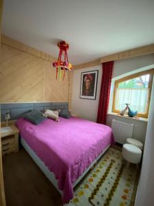 考斯赛力克Apartament Róża的一间卧室设有紫色的床和窗户