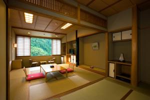日田市真诚日式旅馆的客房设有桌椅和窗户。