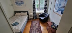 RimboVilla Henrys的一间小卧室,配有一张床和一把椅子