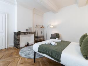 维也纳La petite escapade - Vienna Authentica的一间白色卧室,配有一张床和一个壁炉