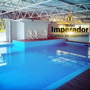 圣阿马鲁-达因佩拉特里斯Hotel Imperador Caldas的游泳池的顶部设有两把白色椅子