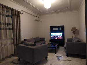 特莱姆森Appartement à louer à Tlemcen的客厅配有2张沙发和1台平面电视