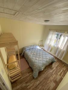 萨尔塔Cabañas La Misión的一间卧室配有一张床,铺有木地板