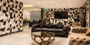 吉达Rasia Hotel Jeddah的带沙发和电视的客厅