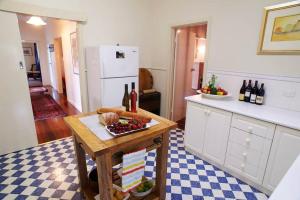 奥尔巴尼Asrama Albany的厨房配有带果盘和葡萄酒瓶的桌子