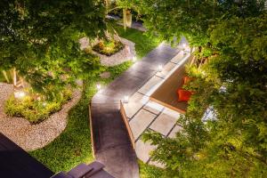 曼谷Hotel Wizpark Ratchada的享有花园的顶部景色,花园内种有长凳和树木