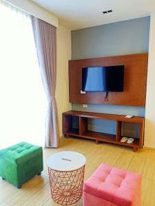 卡尔巴约INNCITY HOTEL的客厅配有平面电视和沙发。