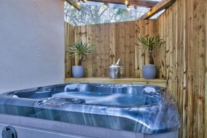 BamptonOlive Cottage by Group Retreats的木墙客房内的蓝色浴缸