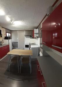 Saint-Jean-aux-BoisLe cailloutis的厨房配有木桌和两把椅子