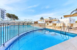 埃斯卡纳Leonardo Suites Hotel Ibiza Santa Eulalia的游泳池周围设有围栏