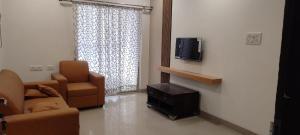 海得拉巴B S Homes的带沙发、椅子和电视的客厅