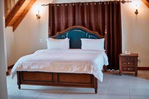 阿鲁沙seven skies hotel的一间卧室配有一张大床和床头板