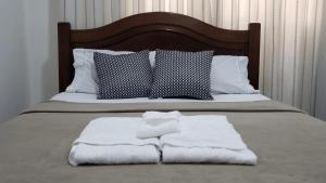 尼泰罗伊Loft Aconchegante Centro Niterói / RJ Inter 300Mb的床上有两条毛巾