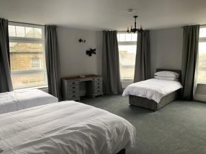 武姆韦尔Churchill's Hotel的一间卧室设有两张床和窗户。