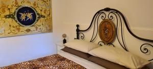 Castel Castagna沉睡的巨人住宿加早餐旅馆的一间卧室,配有一张华丽的床头板