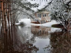 克拉斯拉瓦Atpūta pie upītes的水体旁的雪中房子