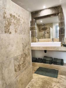 卢马罕Mas provençal, parc de 6000m2, Lourmarin à pied的一间带水槽和镜子的浴室
