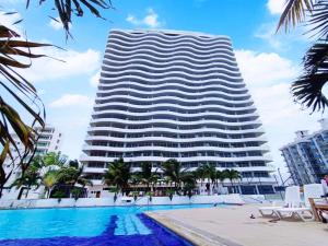 通苏帕Departamento Playero Fountaine Bleau Frente al Mar Tonsupa的大楼前设有游泳池的酒店
