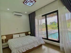 巴位Eagle Bavi Resort的一间卧室设有一张床和一个大窗户