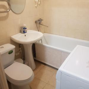 卡拉甘达Однокомнатная квартира в Караганде的浴室配有盥洗盆、卫生间和浴缸。