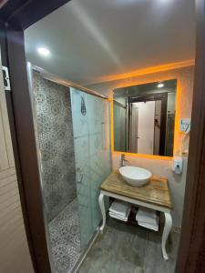 埃斯基谢希尔La Vie Konak Otel的浴室配有盥洗盆和带镜子的淋浴