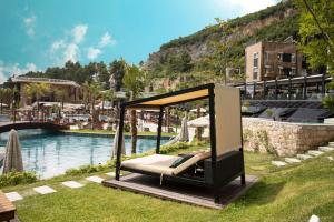 地拉那Select Hill Resort的游泳池旁草地上的摇摆床