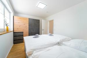 费尔德伯格Mit c的白色的卧室设有一张大床和一个窗户