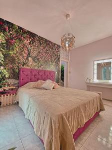阿基欧斯尼古拉斯Ruby Apartment的一间卧室配有一张带粉红色床头板的大床