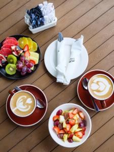 开普敦葡萄园酒店的一张桌子,上面放有水果盘和咖啡杯