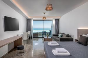 古瓦伊Crete Resort Sea Side Suites "Adults Only" by Checkin的酒店客房设有床和客厅。