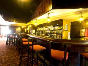 白河Blue Zone Leisure at Pine Lake Inn Resort的酒吧,餐厅里设有一排酒吧凳子