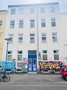 罗斯托克Ruhige Ferienwohnung的一座建筑,上面有蓝色的门和涂鸦